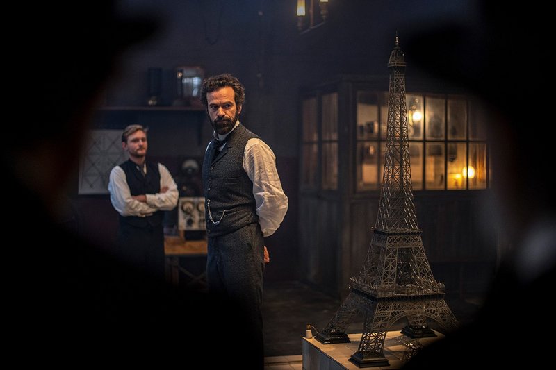 Gustave Eiffel (Romain Duris) with his model for the design of the Eiffel Tower from the film Eiffel, directed by Martin Bourboulon.