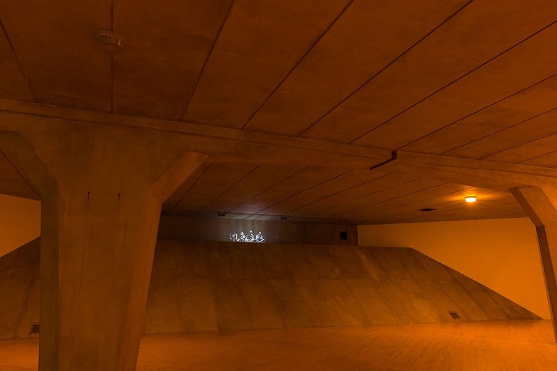 A shaft of light penetrates the underpass from above.