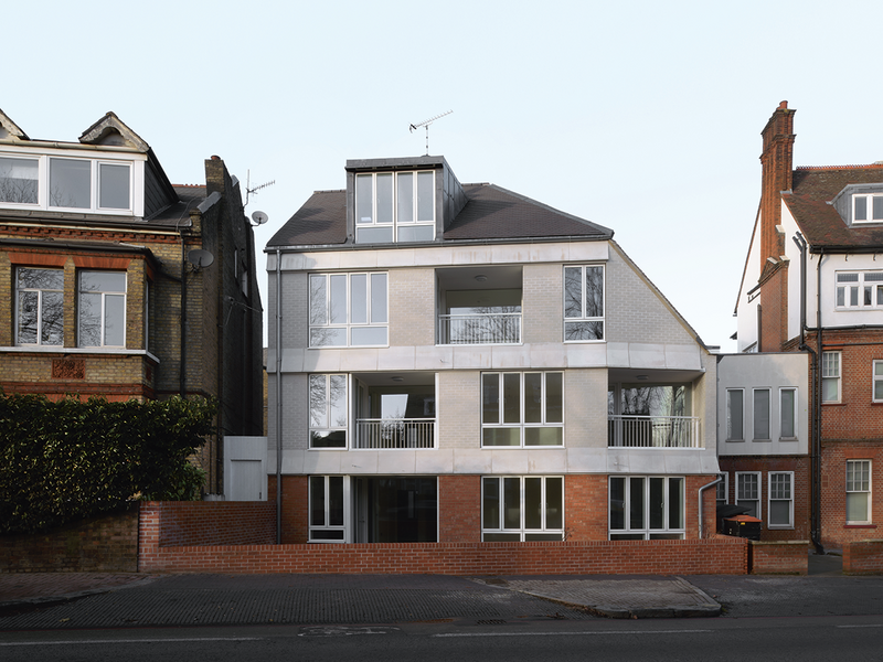 The building’s rear elevation faces West Hill, also known as the A3. Its steeply pitched roof leans away from adjacent Suffolk Hall.