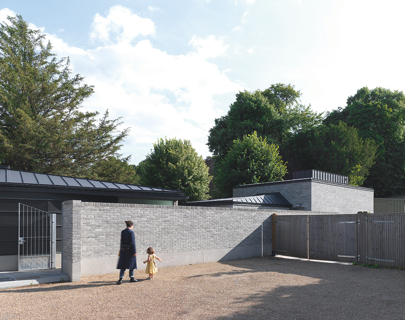 The buildings are positioned along the line of outhouses between the kitchen garden and car park.