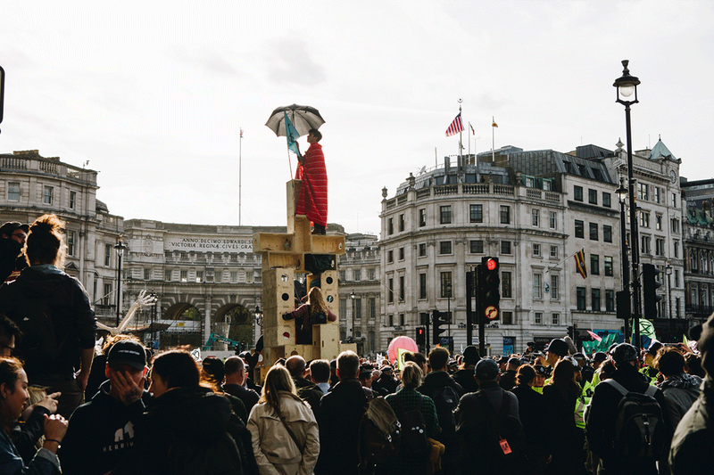 Power to the tower: Protest architecture inspired by 'U-Build' - Studio Bark's Nick Newman stands atop. Boxes were crowdfunded and assembled collectively by participants as part of 'International Rebellion 2' in October 2019.