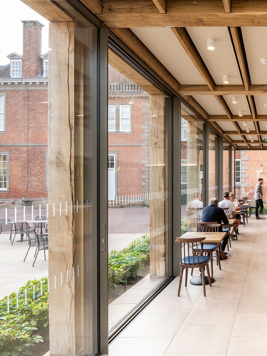 A new Yorkstone terrace lets visitors spill into the courtyard via a Keller Minimal aluminium sliding door system.
