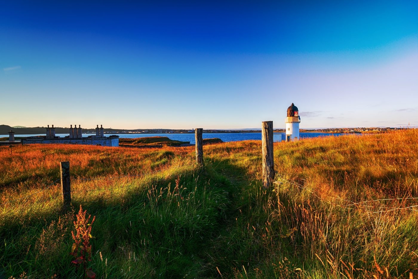 The lighthouse and coastguard cottages at Arnish Point on the entrance to Stornoway harbour on the Isle of Lewis.