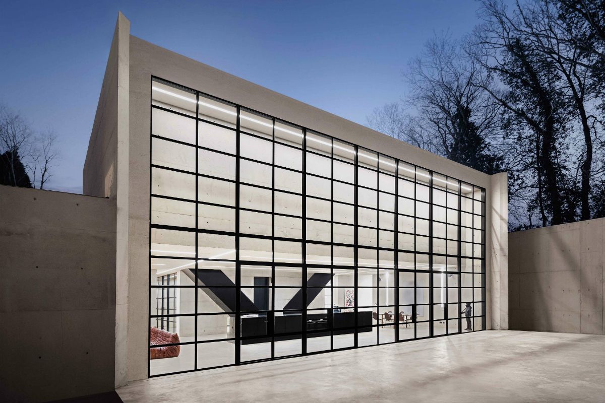 The rear elevation with its concrete and black framed glazed wall that spans the width of the building.