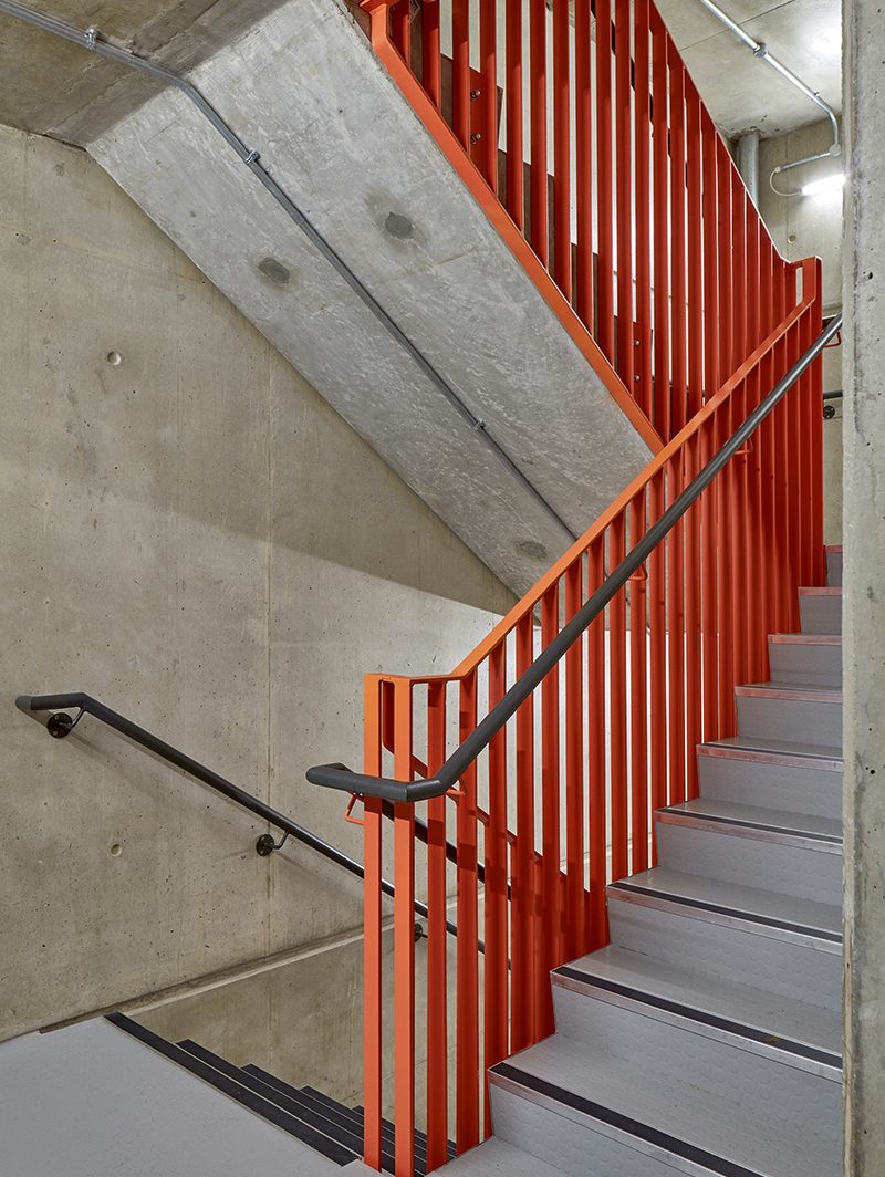 The bright colours on the balustrades run throughout each building, creating joy and identity.