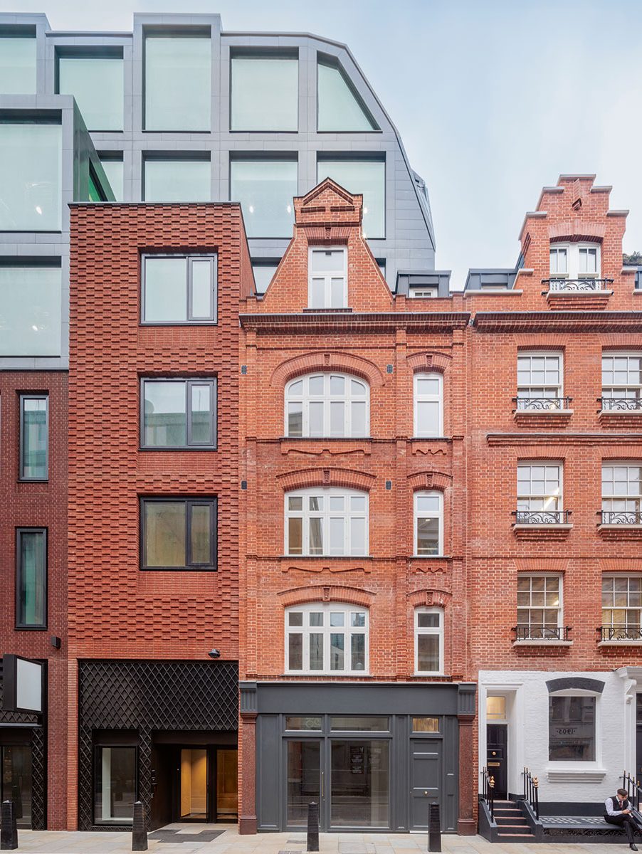 Dismantled and rebuilt brick by brick, Edwardian Soho townhouses along Denman Street, and the new brick continuation to the left.
