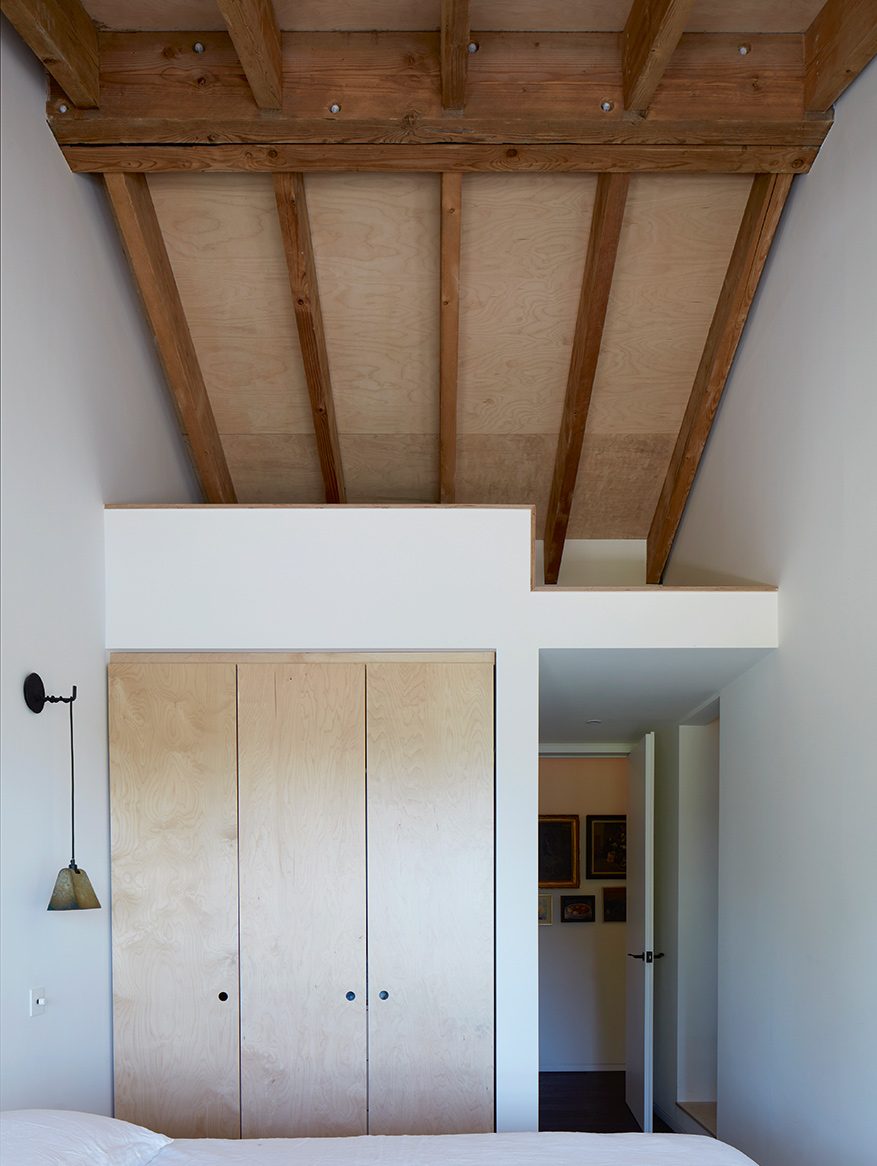 Guest bed room with a sleeping mezzanine tucked into the roof space above.