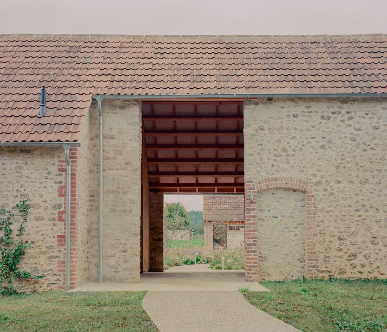 A new 'breezeway' leads from the parking area to the courtyard.