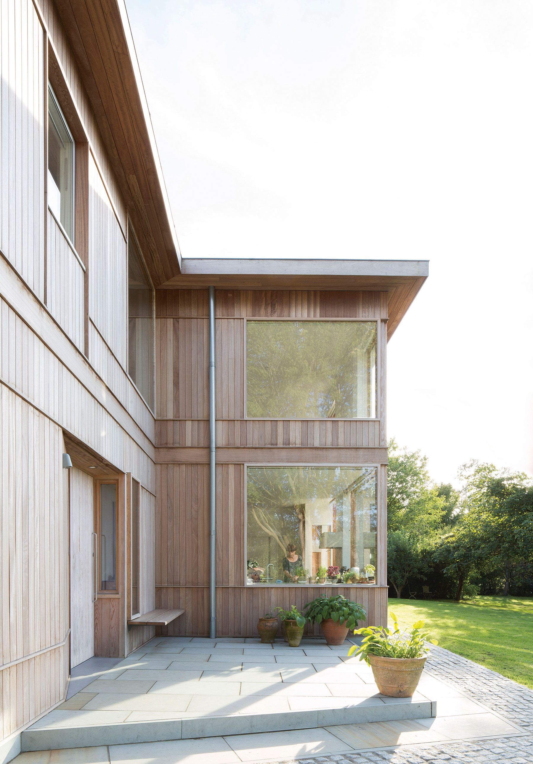 Kitchen sink overlooks the front door to the left. Hardwood iroko cladding, Douglas fir window surrounds and the softwood frame can all be seen at once.
