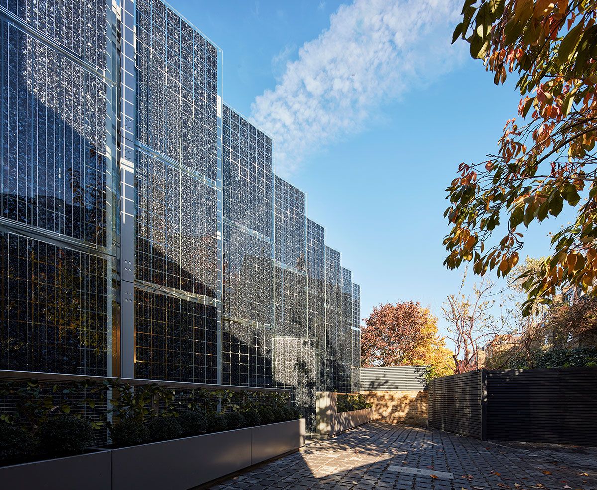 View down the front of the two mews houses in Fulham showing the row of angled solar screens in front of the elevation.