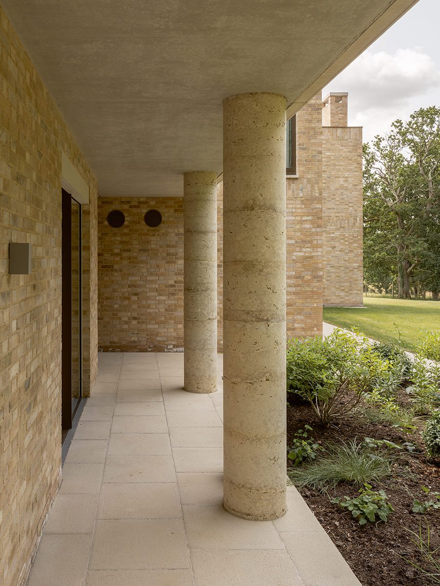 The rear cloister that leads around the annexe to the front door has the same concrete and stone aggregate columns.